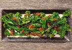 Overhead shot of charred broccolini with XO sauce on a platter