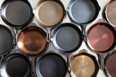 An overhead view of several cast iron skillets