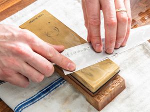 Hands sharpening a knife on a King Fine-Grit Whetstone