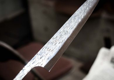 A ground Japanese knife blank, ready to be fitted with a handle, sharpened, and polished.