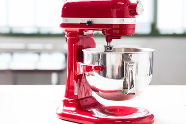 a red kitchenaid stand mixer on a kitchen countertop