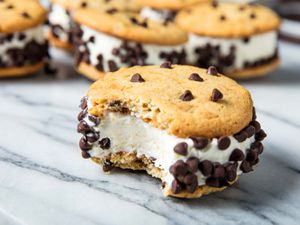 Ice cream sandwiches made with chocolate chip cookies and vanilla ice cream, with mini-chocolate chips rolled on the sides. 