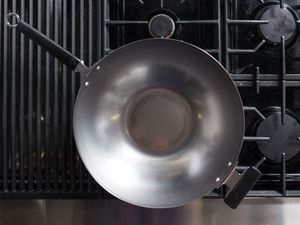 A carbon steel wok on a stovetop