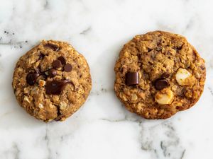 Two cookies side-by-side on a marble surface.