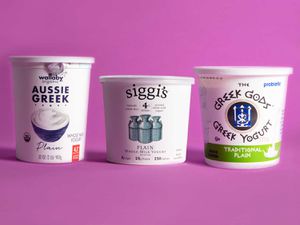 Tubs of our favorite Greek yogurts against a pink background.