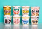 8 varieties of Cup Noodle instant ramen are displayed against a light blue background.