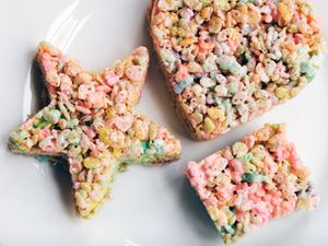 Homemade Peeps Rice Krispy treats cut into a rectangle, a star, and a heart on a plate. 