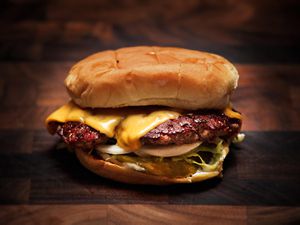 Close-up of a hamburger with cheese on it 