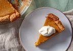 A slice of pumpkin pie on a plate.