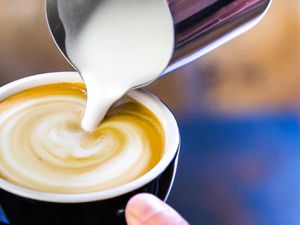 a close up of a latte being made with a non-dairy milk