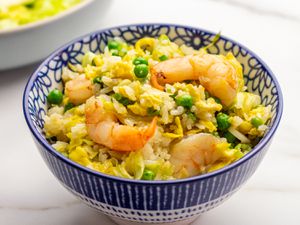 shrimp fried rice in a small blue and white bowl