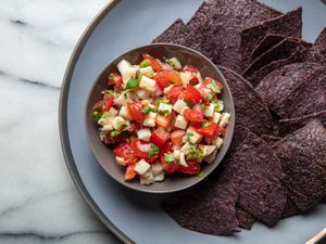 hearts of palm salsa with blue corn chips on a plate