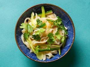 Bowl of potato starch noodles in sesame dressing on a countertop