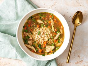 Chicken & rice soup in a white bowl.