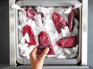 Overhead view of picking a boli out of a freezer