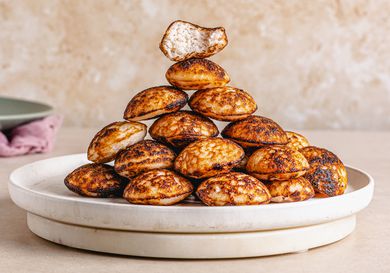 Side view of Nigerian Masa stacked in a pyramid on a plate.