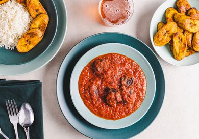 Overhead view of beef stew served with plantains and rice