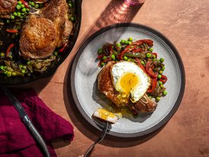 Overhead view of a plate of Costillas a la Riojana with an egg on top