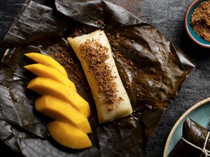 Overhead view of suman next to a cut mango topped with sugar