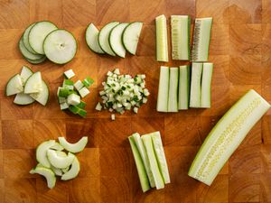 Overhead view of cucumbers cut in a bunch of different ways