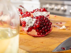 Side view of pomegranate on a cutting board 