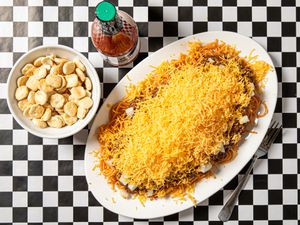 Overhead view of cincinnati chili on a black and white checkered background