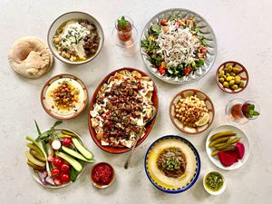 Overhead view of tablescape of multiple hummus plates