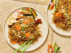 Stir-fried noodles with vegetables on a plate.