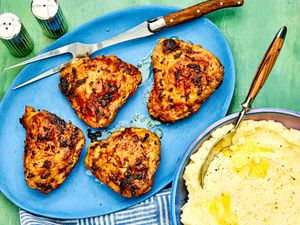 A plate of air-fryer chicken thighs and a side of mashed potatoes