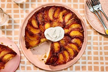 Overhead view of finished peach upside down cake with a slice removed