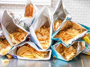 Side view of open bags of potato chips