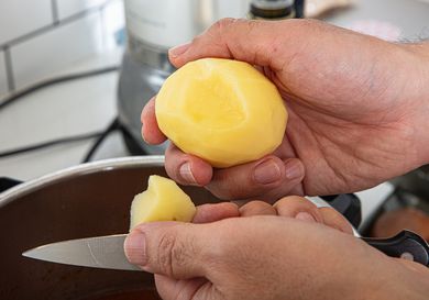 Side view of cutting a potato in chunks