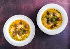 two bowls of Shurabet el Eid on a dark purple background