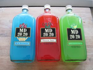 Three bottles of MD 20/20 next to each other: blue raspberry, dragon fruit, and kiwi-lemon. 