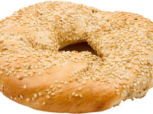 A sesame-seed covered flagel, or flat bagel. 