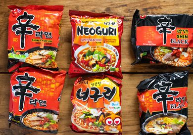 Overhead view of American and Korean versions of Nongshim instant noodles.