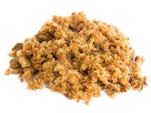 A pile of pork floss resting on a white surface.