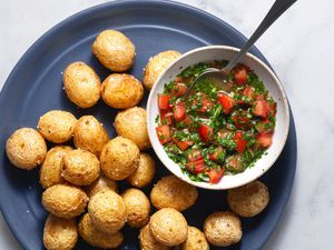 Aji­ (Colombian-Style Tomato and Onion Salsa) in a bowl, served with potatoes