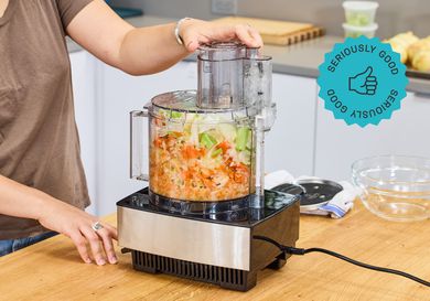 A person using a food processor to make mirepoix.