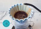 Water being poured into a pour-over coffee device.