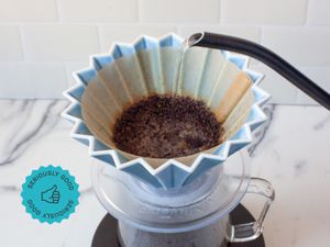 Water being poured into a pour-over coffee device.