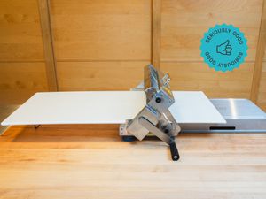 a dough sheeter on wooden kitchen countertop