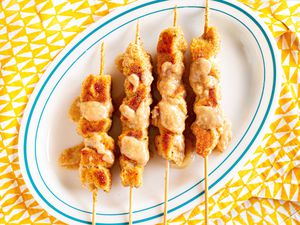 A plate of city chicken (breaded, skewered pork) 