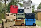 A number of coolers stacked on top of each other in a backyard.