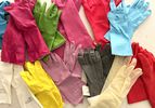 A collection of colorful dish gloves on a counter