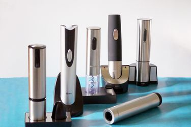 Six electric corkscrews on a blue countertop 