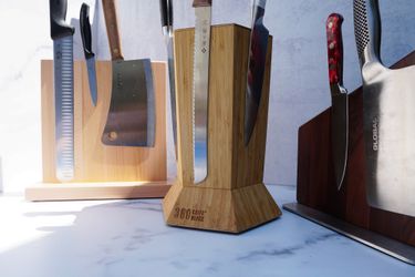 three knife blocks with knives on it on a marble surface