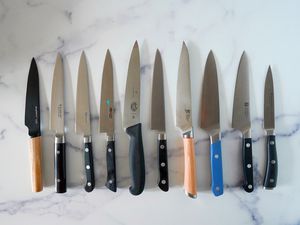 the lineup of petty knives we tested on a marble countertop