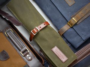 an overhead shot of a variety of knife rolls on a gray surface