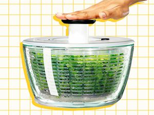 One-Off Cadillac of Salad Spinners hand pushing down on salad spinner